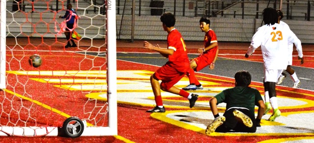 : Corona’s Martin Nunez (right of middle) fires in a goal as the Panthers defeated Riverside Poly 5 – 1.