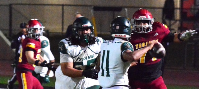 Tahquitz lineman Aydan Mapuatuli (58) has Hillcrest defensive lineman Justin Escalante (77) get past him and pressure QB Michael Razee (11).