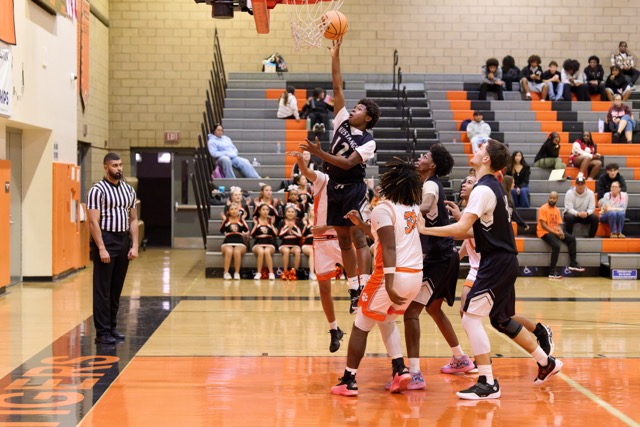 The San Jacinto Tigers scratched out the win over the West Valley Mustangs in a Mountain Pass league game. Mustangs #12 Hakeim Hodges jumps up in the key to make a 2 pointer