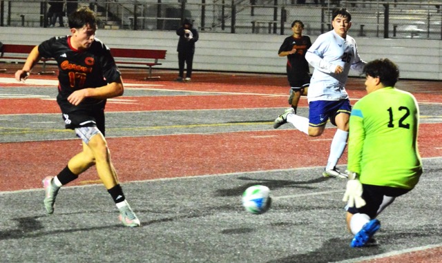 Corona’s Conrad Garcia (17) fires in a shot past the Riverside North goalie. The Panthers pummeled the Huskies 8 – 1 on a rainy night in Corona.