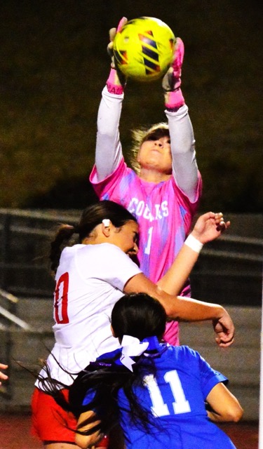 Norco goalie Ryley Rocheleau (1) makes a game-saving grab on a corner kick as Corona’s Ella Towers collides with her as the game winds down. The Cougars’ Kairi Chacon (11) watches. The game ended in a scoreless tie.