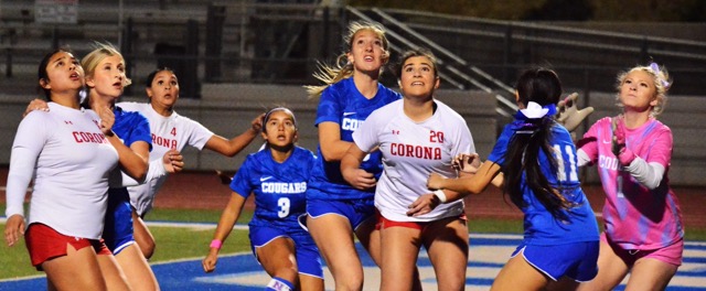 Norco and Corona players are locked on the flight of the ball as the final corner kick of their match heads toward the Cougar Goal. (L-R) Sophie Martinez, Jaelynn Rugg, Monique Garcia (4), Makayla Pacheco (3), Briana Sousa (9), Ella Towers (20), Kairi Chacon (11) converge on Cougar goalie Ryley Rocheleau (1), who made the save, preserving a scoreless tie.