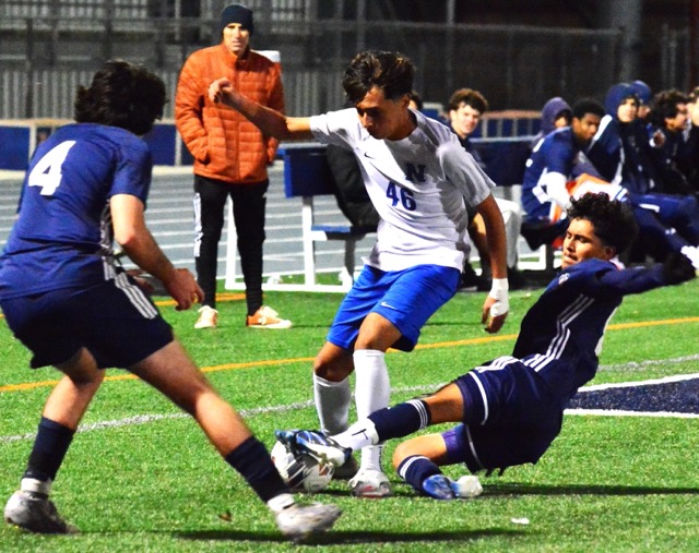 Eastvale Roosevelt’s Lucca Falla (4) watches teammate Alex Gomez (right) put the slide tackle on Norco’s Leonal Arevalo (46), during the Mustang’ 2-1 win over the Cougars