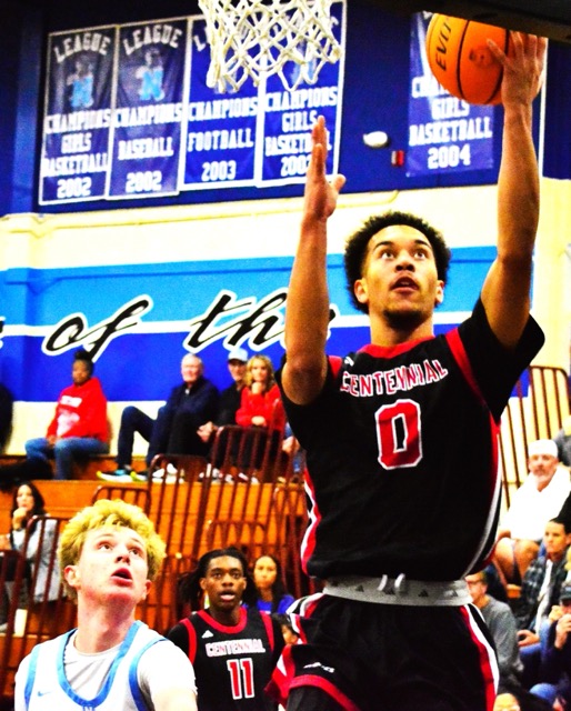 Norco’s Matthew Partridge (left) and Centennial’s Josh Agbo (11) watch Kai Patton (0) score a layup during the Huskies 89-21 dismantling of the Cougars.