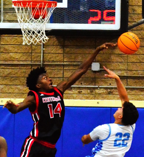 Corona Centennial’s Ian Awoleye (14) rejects a shot by Norco’s J. Ayala (22).