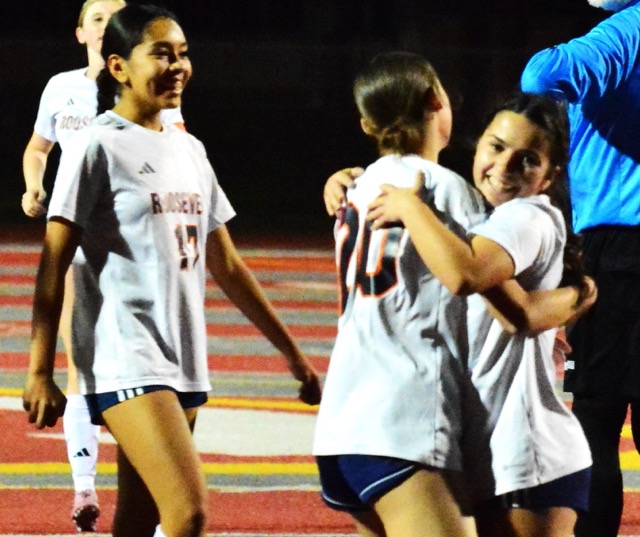 Eastvale Roosevelt’s Juliette Gomez (17) and Aubree Austin (20, center) celebrate with Kamryn Rembis (right) after Rembis scored the game tying goal against Corona. The Mustangs added two more to beat the Panthers 3 – 1.