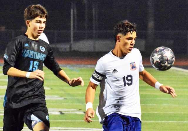 Corona Santiago’s Lloyd Merryman (15) chases Eastvale Roosevelt’s Jaxon Haroldsen (19) during the Sharks 2 – 1 victory over the Mustangs.
