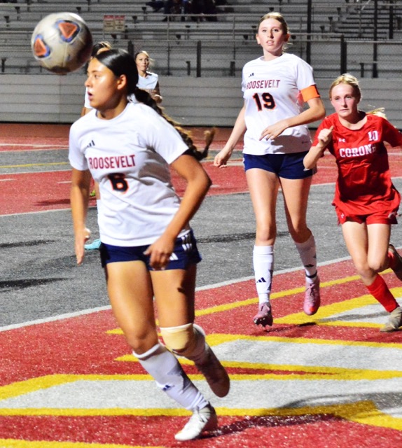Eastvale Roosevelt’s Cambria Yatomi (6) gets the ball out of the grease after her goalie Zoryah Davis made an incredible block on a Corona shot. Avery Mendez (19) and Corona’s Adison Holtz (10) give chase.