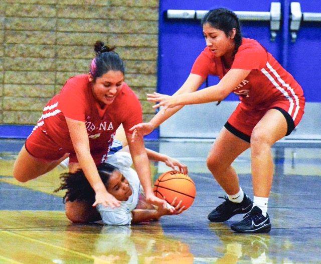 Fiercely competitive no matter the score, Aissis Ascencio (left) and Alex Flores (right) and Norco’s Mya Smith dive on the deck chasing a loose ball during the Panthers 72 – 12 victory over the Cougars.
