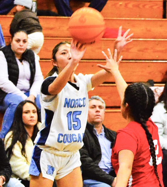 Norco’s Sinclair Smith (15) shoots over Corona’s Alex Flores, in the Panthers 72 – 12 victory over the Cougars.