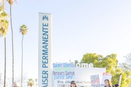 Kaiser Permanente nurses and healthcare workers represented by UNAC/UHCP participate in the 2026 strike, calling for improved wages, lower patient-to-nurse ratios, and stronger retirement benefits.  Credit: Photo by Lisa Zambrano