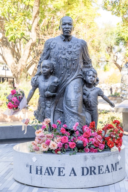 The MLK Jr. memorial statue in Riverside is covered in flowers, Monday, honoring Martin Luther King Jr.’s legacy of equality, peace, and service. Dr. King was assassinated on April 4, 1968