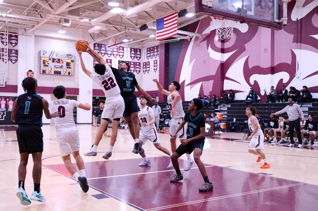 Paloma Valley’s #22 Ayden Garcia comes up with a rebound while fighting to keep possession