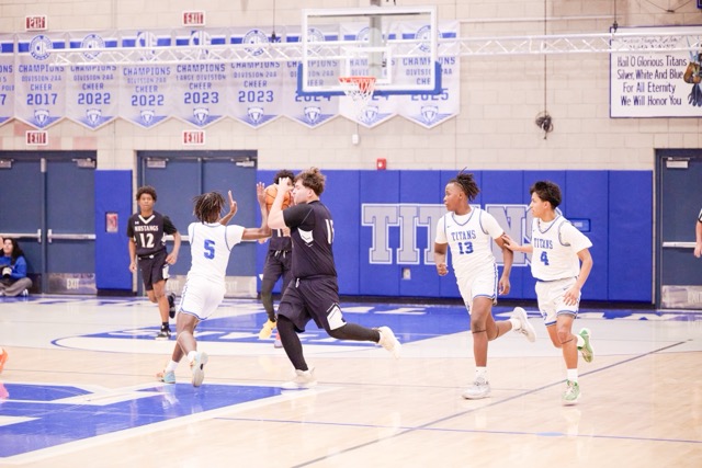 Titans #5 Jahden Johnson steals the ball from Mustangs #15 Connor Saenz