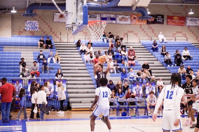West Valley’s #23 Alakai Farley shoots a tough fade away 2 pointer over #13 Michael Chambers