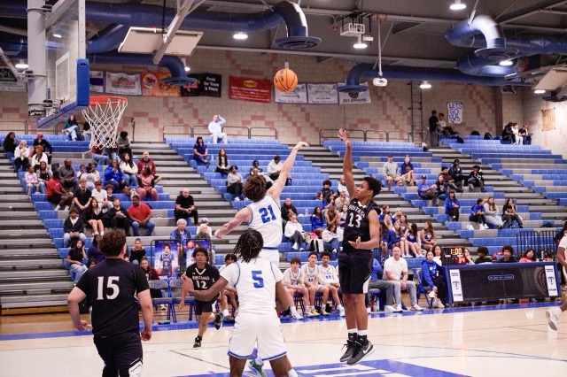Mustangs #23 Alakai Farley launches a floater up and over #21 Carson Gray for a contested 2 points. The Temescal Canyon Titans defeated The West Valley Mustangs Tuesday night, 74-47 in a boys basketball Mountain Pass league game