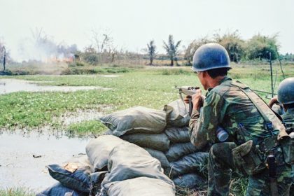 January 30. South Vietnamese Rangers fire at a suspected Viet Cong position in a clump of bushes in Binh An Village, in the 7th Precinct of Saigon, March 1, 1968. The area was hit hard in the early days of the Tet Offensive and left many demolished homes, churches and other structures.  Credit: AP Photo