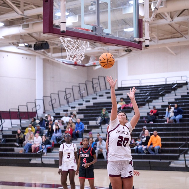 #20 Mianna Bravo takes an easy shot under the basket for the Wildcats
