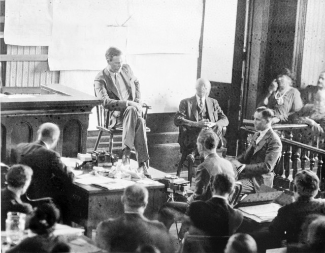 February 13. . Lindbergh testifying at Hauptmann's trial. Hauptmann is in half-profile at right. Credit: Library of Congress