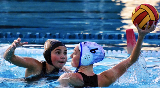 Corona Santiago’s Riley Romero (11) eyes the ball while Los Alamitos Hailey Rippeon (6) looks to pass during the first round CIF playoff match. The Sharks held off the Griffins 10 – 8.