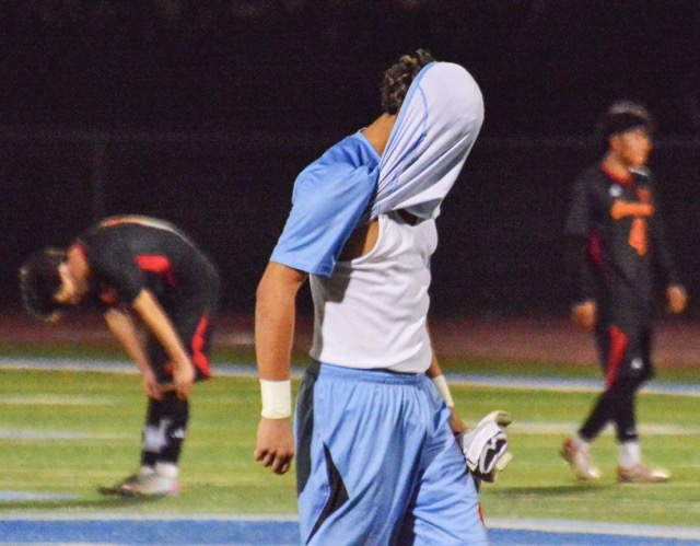 Corona goalkeeper Chris Salazar (1) covers his head in disappointment after his Panthers fell to the Norco Cougars.