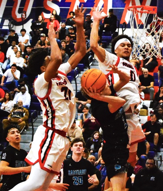 Corona Centennial’s Isaiah Rogers (21) and Kai Patton (0) get ready to lower the boom on Santiago’s Evan Nayback (2). Rogers blocked and controlled the ball. Tied at halftime at 28, the Huskies dominated the 2nd half, winning 59 to 38.