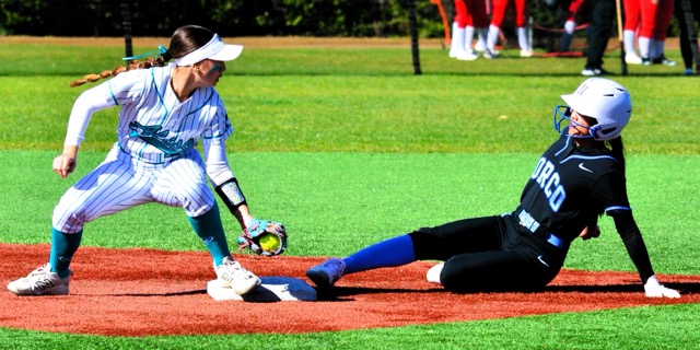 It’s a game of inches as Norco’s Sasha Pham slides into second base just before Aliso Niguel’s Lindsey Hubbard applies the tag. The Cougars defeated the Wolverines 3 – 0 in eight innings in tournament play.