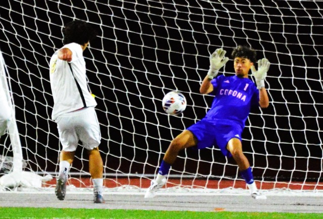 Corona goalkeeper Chris Salazar blocks a Canyon shot.