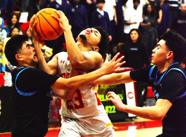 Walnut’s Kiko Guevara (left) fouls and feels the impact from Corona’s Jordan Williams (23) elbow on a layup attempt while Jacob Ventura (right) tries to defend during second-round CIF playoff action. Jeremiah Vasquez hit a last-second desperation buzzer-beating 3-pointer to give the Mustangs a 71 – 70 victory over the Panthers.
