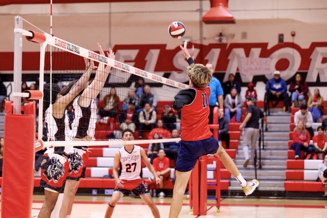 A last ditch attempt to float the volleyball over the net comes up short