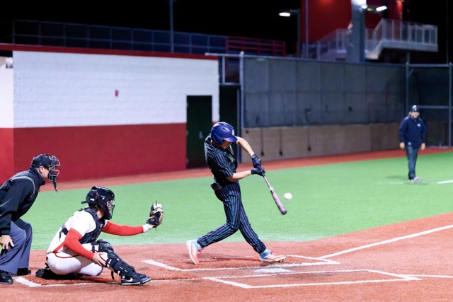 The Murrieta Mesa Rams defeat the Elsinore Tigers, 4-0, in their first game of the baseball season. Murrieta Mesa’s #13 Adam Paine rips a pitch up the middle for a single with no outs.
