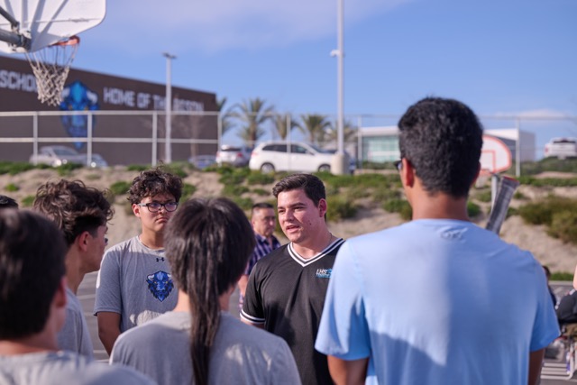 Head coach for Liberty high school Tyler Baca talks to his team to go over strategy