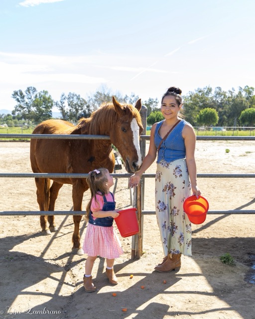 Mom and Daughter, Andraha and Olivia, feed Red, the horse, at the Coffee with Horses event at T.H.E. Center Inc. in Hemet last Saturday.
