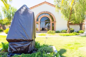 A tribute statue of Cesar Chavez is covered in front of the City of Perris Cesar E. Chavez Library on Monday, March 23, 2026