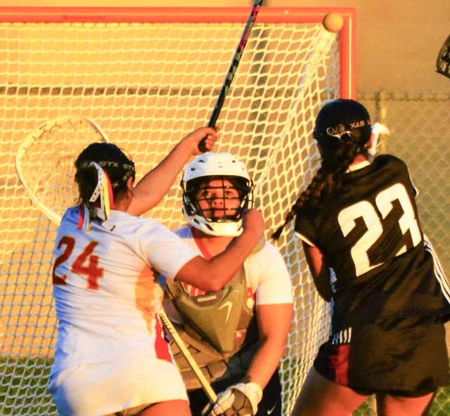 Corona’s Zadie Perez (24) watches goalie Guadalupe Roriguez Ortiz (center) eye the shot from an El Modena player during the Vanguards’ 20 – 1 victory over the Panthers.