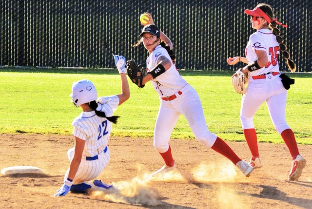 After completing the force at 2nd before Norco’s Sadie Burroughs (22) slid in, Centennial shortstop Teuuaina Sanchez completes the double-play with her throw to 1st. But the Cougars prevailed 14-0.