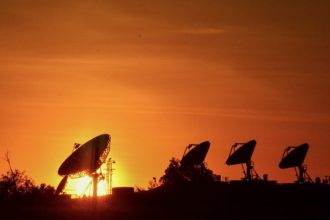 The array of satellite dishes lining the Naval Sea Systems Command facility in Norco is silhouetted against Monday’s scorching setting sun. Credit: Photo by Gary Evans