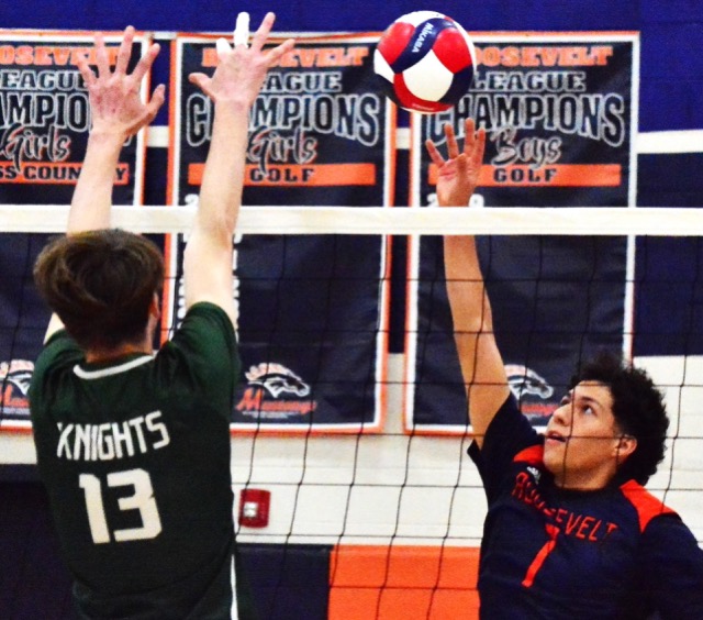 Ontario Christian’s Lucas Tobin (13) tries to block a dink over the net by Roosevelt’s Noah Torres (1) during the Mustangs 3 – 0 victory over the Knights