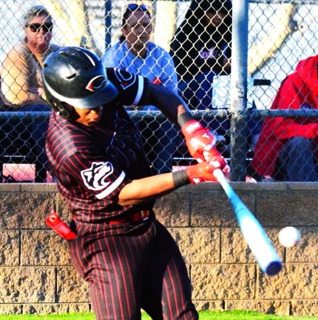 Corona Centennial’s Jaden Walk-Green hammers the ball to the left center field wall. The wind held the ball up to the warning track for an out, but the sacrifice fly scored a run during the Huskies’ league win.