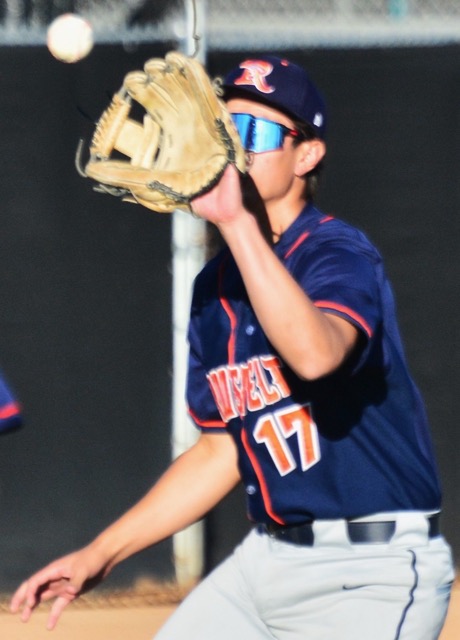 Eastvale Roosevelt third baseman Lucas Hernandez (17) fights the sun on a chopper to third that he threw to first for the putout.