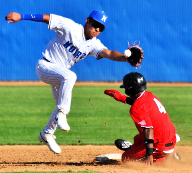Norco’s second baseman Zion Martinez (left) leaps for the throw from catcher Jayden Serna as Centennial’s Jaden Walk-Green (4) steals second base. The Cougars overcame a 4 – 0 deficit to defeat the Huskies 8 – 4.