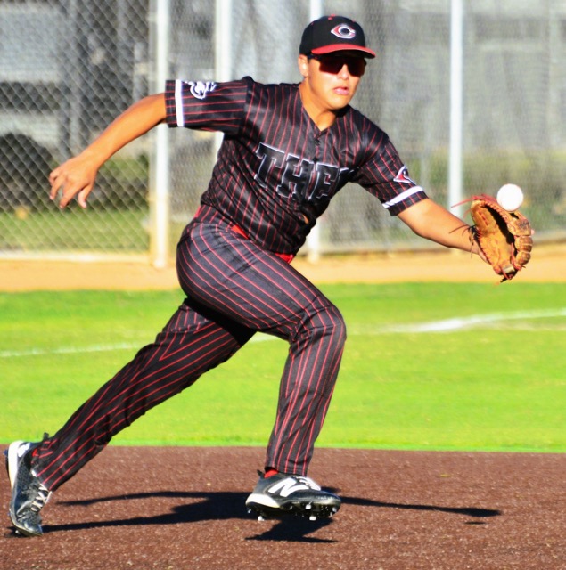 Corona Centennial third baseman Emiliano Castaneda reaches for a bouncer hit by Roosevelt’s Lucas Hernandez. Castaneda’s throw to first pulled the first baseman off the bag allowing the speedy Hernandez to be safe.