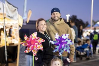 Kristen and Ryan Halstrum watch over their daughter as she navigates Foodie Friday in her pink pinwheeled Power Wheels on the campus of Mount San Jacinto Menifee Campus last Friday. Credit: Lisa Zambrano