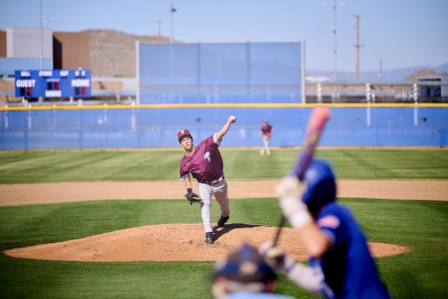 Wildcats #14 Ryder Bland pitches to Bison #5 Dylan Oltjenbruns whose hand creeps up the bat to bunt...