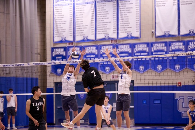#7 Kevin Garcia attempts to power through a formidable Temescal Canyon double-block at the net.