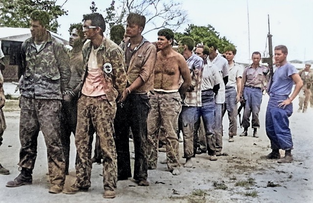 Colorized Photo. Members of the invading force, Brigade 2506, surrender to Cuban soldiers. They were tried, convicted, some executed, and imprisoned until December 1962 when an agreement was struck to return them to the United States in exchange for $53 million in food and medicine.  By Miguel Vinas - Warfare Blog