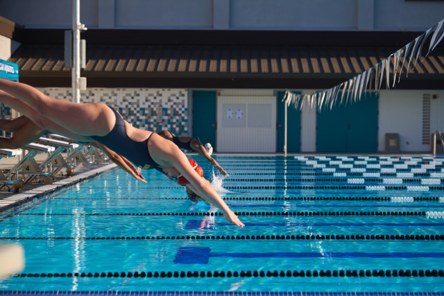 Canyon Springs and Arlington swimmers hit the water simultaneously during a sprint start during Wednesday’s dual meet at Moreno Valley High School.
