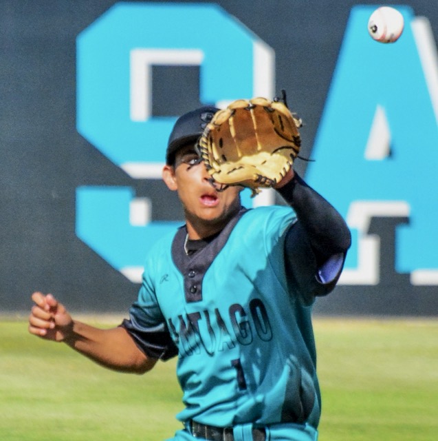 Corona Santiago’s Ben Rausch (1) eyes a hard chopper hit by Corona’s Trey Ebel in the first inning, who beat the throw.