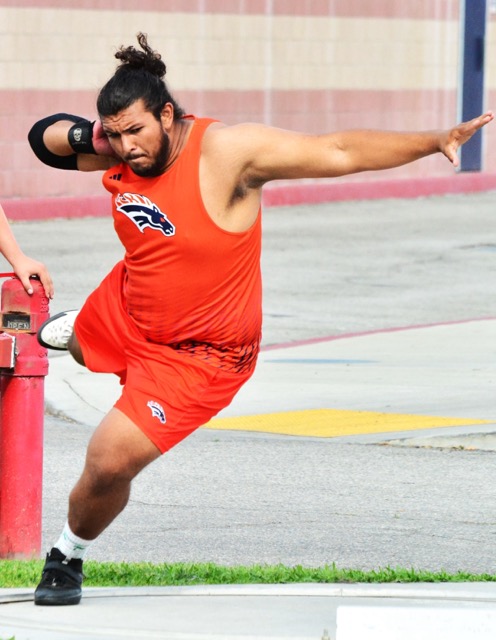 Roosevelt’s Xavier Farfan spins to launch the shot put at last week’s meet against Norco.  Farfan took first place. 
