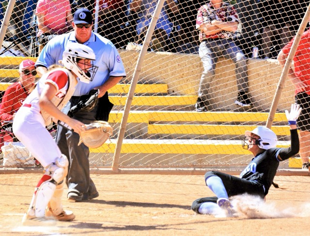 Norco’s Rae Logue (right) slides into home with a run during the Cougars 2 – 0 victory over Orange Lutheran.